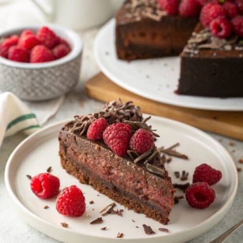 Slice of Decadent Chocolate Raspberry Cake served with garnish