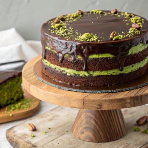 chocolate cake with pistachio cream on wooden cake stand