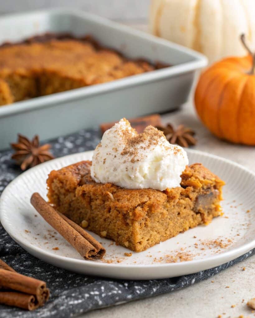 a warm slice of vegan pumpkin dump cake served on