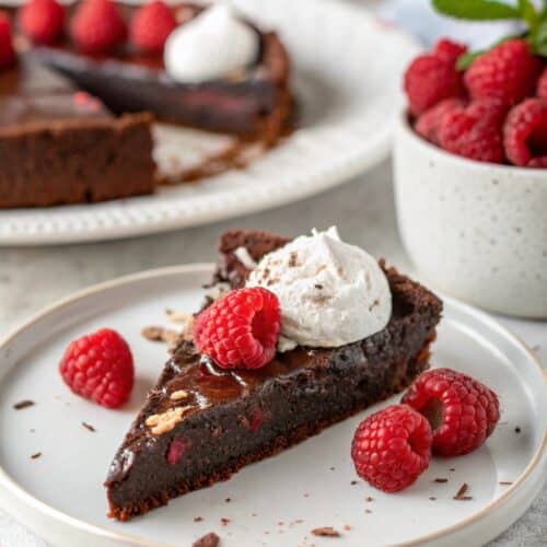 Slice of vegan flourless chocolate cake served