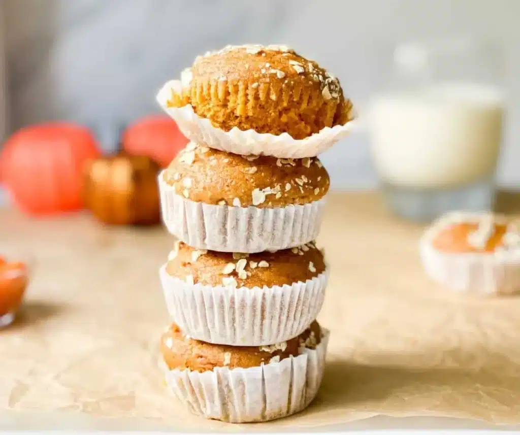 Deliciously healthy 57 calorie pumpkin spice muffins on a wooden table.