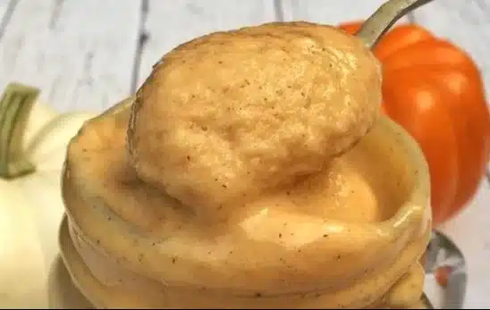 Healthy pumpkin pie smoothie in a glass topped with whipped cream and cinnamon