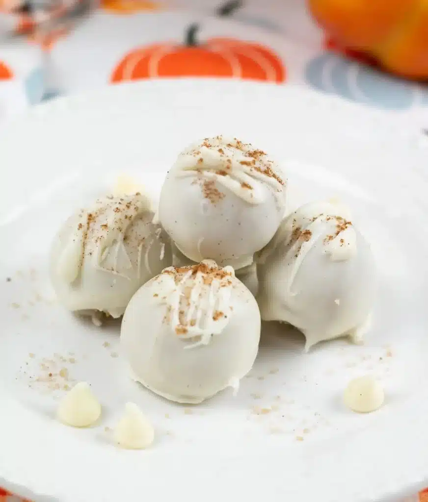 Delicious no bake pumpkin balls coated in coconut and nuts.