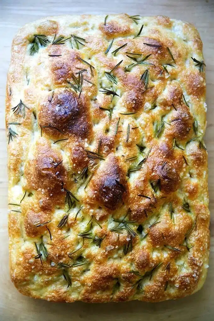 Freshly baked focaccia bread topped with herbs and olive oil